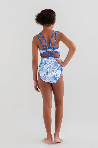 Back view of a girl wearing the Bettina Blue Leotard with intricate blue straps and a floral print, inspired by French Toile.